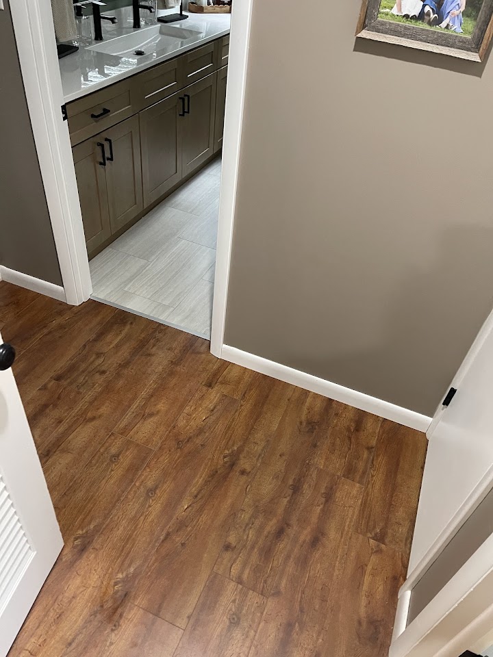 Hallway flooring leading into bathroom remodel